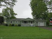 Charming single-story home featuring a well-maintained lawn and inviting front porch at 229 Arnold St, Morgantown, IN 46160