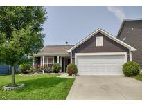 Charming home featuring a manicured lawn and a two-car garage, complemented by rose bushes at 2432 Bridlewood Dr, Franklin, IN 46131