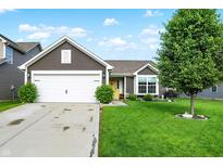 Charming home with a well-maintained lawn, two car garage, and inviting yellow front door at 2538 Bridlewood Dr, Franklin, IN 46131