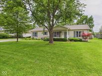 Charming ranch-style home with lush green lawn, mature trees, and well-maintained landscaping at 3004 N Timber Ln, Muncie, IN 47304