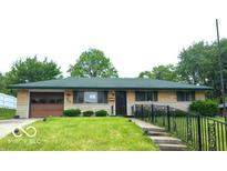 Charming one-story home features a well-maintained lawn and an attached one-car garage at 317 Grovewood Dr, Beech Grove, IN 46107