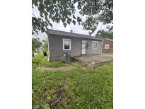 Charming gray house featuring a small front porch area and verdant lawn at 3202 N Emerson Ave, Indianapolis, IN 46218