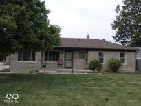 Charming ranch-style home with stone exterior, well-maintained lawn, and inviting front porch at 3456 S Sadlier S Dr, Indianapolis, IN 46239
