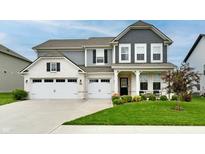 Beautiful two-story home with a manicured lawn, charming landscaping, and a three car garage at 3872 New Battle Ln, Bargersville, IN 46106