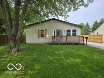 Charming single-story home featuring a welcoming front porch and well-maintained lawn with mature trees at 450 N Fenton Ave, Indianapolis, IN 46219