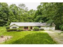 Charming ranch-style home with a well-manicured front yard and a welcoming red door at 5975 S 800 E, Zionsville, IN 46077