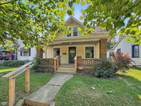 Charming two-story home featuring a welcoming front porch and a well-maintained yard at 621 N Livingston Ave, Indianapolis, IN 46222