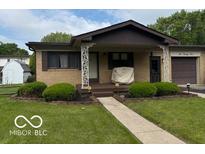 Charming single-story home featuring a well-maintained front yard and covered porch at 624 S High School Rd, Indianapolis, IN 46241