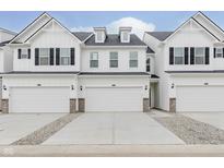 Charming white townhome with a two-car garage and beautifully designed exterior features at 7330 Shroyer Way, Noblesville, IN 46062