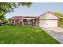 Charming single-story home with a well-maintained lawn and inviting front porch at 7418 Southern Lakes Dr, Indianapolis, IN 46237