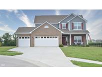 Charming two-story home boasts a brick and siding facade with a two-car garage and well-manicured lawn at 925 Bent Branch Cir, Greenwood, IN 46143