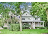Charming two-story home with a welcoming front porch and mature trees in a beautifully landscaped yard at 9698 Coyote Ct, Noblesville, IN 46060