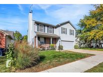 Charming two-story home with light gray siding, green shutters, and a well-manicured lawn at 1024 Rotherham Ln, Beech Grove, IN 46107