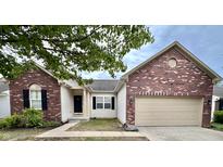 Charming home featuring a brick facade, attached garage, and well-maintained landscaping at 10725 Tedder Lake Dr, Indianapolis, IN 46239