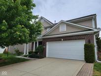 Two story house with brick accents and a two car garage is showcased in this exterior home image at 11070 Long Lake Ln, Fishers, IN 46037