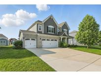 Charming two-story home featuring a three-car garage and well-maintained lawn at 1221 Hamilton Dr, Greenwood, IN 46143