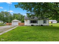 Charming single-story home with a well-maintained front yard, detached garage and ample green space at 1382 S Morgantown Rd, Greenwood, IN 46143