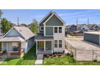Charming two-story home with a welcoming front porch and fresh landscaping at 1405 Deloss St, Indianapolis, IN 46201