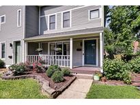 Charming home with a cozy porch, manicured landscaping, and inviting curb appeal at 1548 N Park Ave, Indianapolis, IN 46202