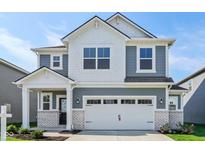 Two-story home boasts a white garage door, stylish gray siding, and a welcoming front porch at 1669 Windrush Pl, Westfield, IN 46074
