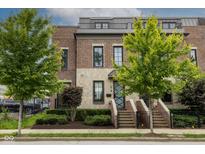 Charming multi-story brick home featuring manicured landscaping and a gated entry at 1818 N Pennsylvania St, Indianapolis, IN 46202