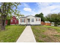 Charming bungalow with a well-maintained lawn and inviting walkway at 2164 E Raymond St, Indianapolis, IN 46203