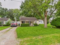 Charming one-story home featuring a well-maintained lawn and inviting front porch at 2405 E 9Th St, Anderson, IN 46012