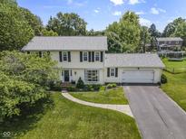 Traditional two-story home featuring a manicured front lawn and attached two car garage at 321 4Th E Ct, Carmel, IN 46033