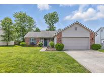 Charming single-story home with a well-manicured lawn and a two-car garage at 34 Westview Pl, Bargersville, IN 46106