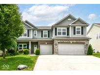 Charming two-story home with a well-manicured lawn, two-car garage, and beautiful stone and siding exterior at 4650 Blue Marlin Way, Indianapolis, IN 46239