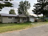 Charming single-story home with vinyl siding, metal roof and attached one car garage at 501 W Taylor St, Alexandria, IN 46001