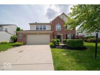Charming two-story home with a two-car garage and well-maintained landscaping at 5883 Sandalwood Dr, Carmel, IN 46033