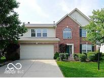 Charming two-story home with a brick facade, attached two-car garage, and well-maintained landscaping at 5883 Sandalwood Dr, Carmel, IN 46033