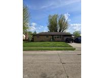 Charming brick home with a well-manicured lawn and driveway, perfect for suburban living at 6133 Ashway Ct, Indianapolis, IN 46224