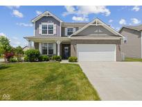 Two-story home with brick and siding, manicured lawn, and attached two-car garage at 632 Albermarle Dr, Pittsboro, IN 46167