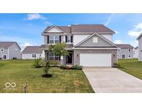 Charming two-story home with a well-manicured lawn and a two-car garage at 6507 W Whispering Way, Greenfield, IN 46140