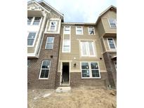 A beautiful new build townhome with brick and siding, and white trim on a cloudy day at 7317 Bayview Run, McCordsville, IN 46055
