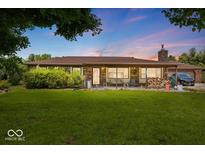 Charming single story home featuring a covered front porch and a sprawling green lawn at 8244 E Hadley Rd, Camby, IN 46113