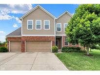 Charming two-story home boasts a three-car garage, landscaped yard, and classic curb appeal at 916 Settlers Walk, Brownsburg, IN 46112