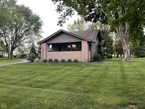 Charming single-story home with a well-maintained lawn and inviting front porch at 9467 N Michigan Rd, Fairland, IN 46126