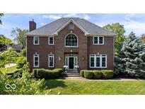 Beautiful brick two-story home with manicured lawn and mature landscaping at 9973 Woods Edge Dr, Fishers, IN 46037