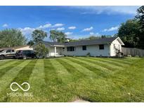 Charming single story home featuring a well-manicured lawn and mature trees in a suburban neighborhood at 101 E Hill Valley E Dr, Indianapolis, IN 46227