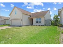 Charming home featuring a two-car garage, neat lawn and lovely curb appeal at 10693 Newgate Ln, Indianapolis, IN 46231