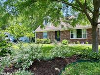 Charming brick home with a well-maintained front yard and lush landscaping at 1129 Nantucket Dr, Cicero, IN 46034