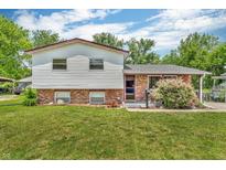 Charming two-story home with white siding, brick foundation, and a well-manicured front yard at 3624 Woodcliff Dr, Indianapolis, IN 46203