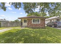 Charming brick home with a well-maintained lawn and mature trees in a quiet neighborhood setting at 3898 S Randolph St, Indianapolis, IN 46227