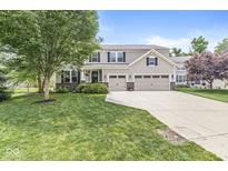 Charming two-story home featuring a three-car garage and a well-manicured front lawn at 4642 Big Run Ct, Indianapolis, IN 46239
