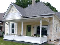 Charming front porch with white columns, a brick base, and a cozy seating area at 554 W Taylor St, Shelbyville, IN 46176