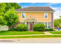 Charming two-story home with a well-manicured lawn and inviting front entrance at 5677 Brownstone Dr # 5677, Indianapolis, IN 46220