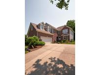 Lovely two-story brick home with a two car garage, beautiful landscaping, and a large driveway at 6483 Royal Oakland Dr, Indianapolis, IN 46236